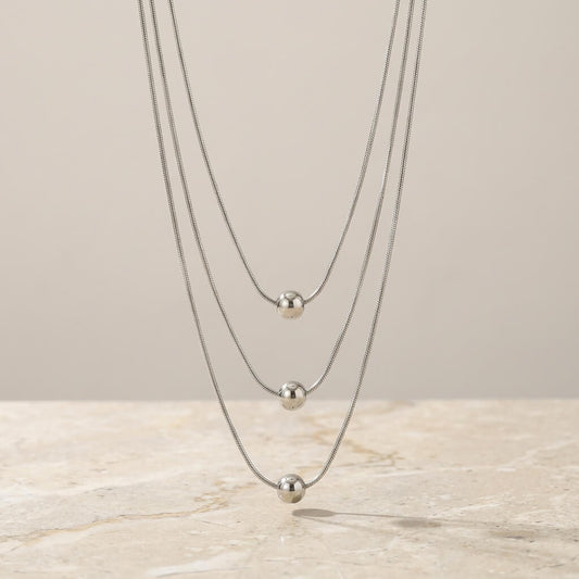 Collier ras de cou multi-rangs perles métalliques